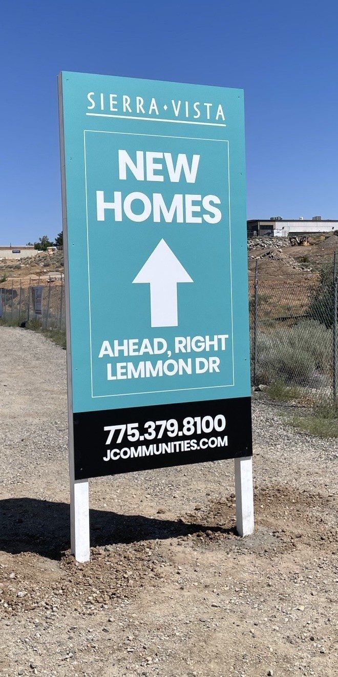 Installed Sierra Vista directional sign reading New Homes, ahead right on Lemmon Drive